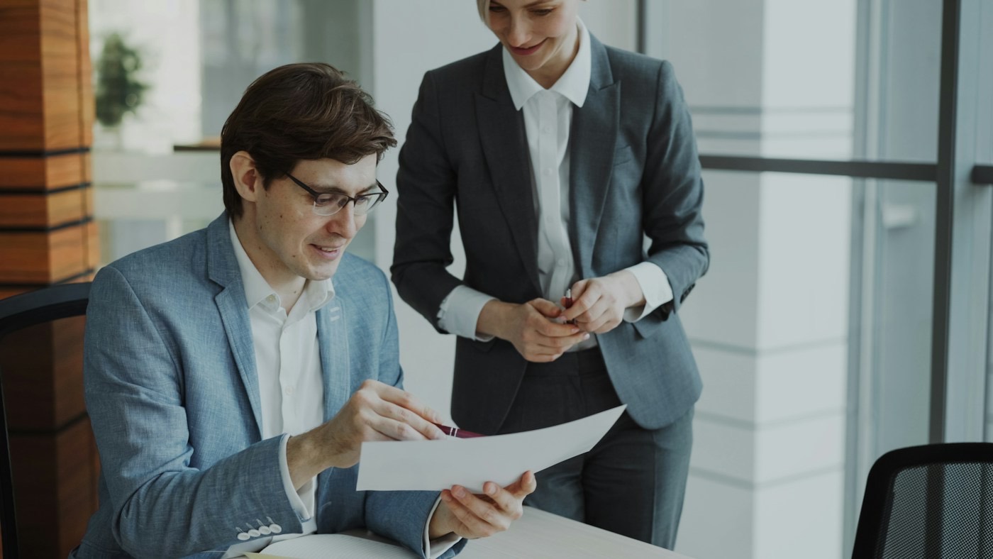 Two colleagues reviewing a document together
